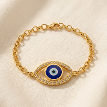 Pulseira dourada com olho grego cravejado em verniz italiano.