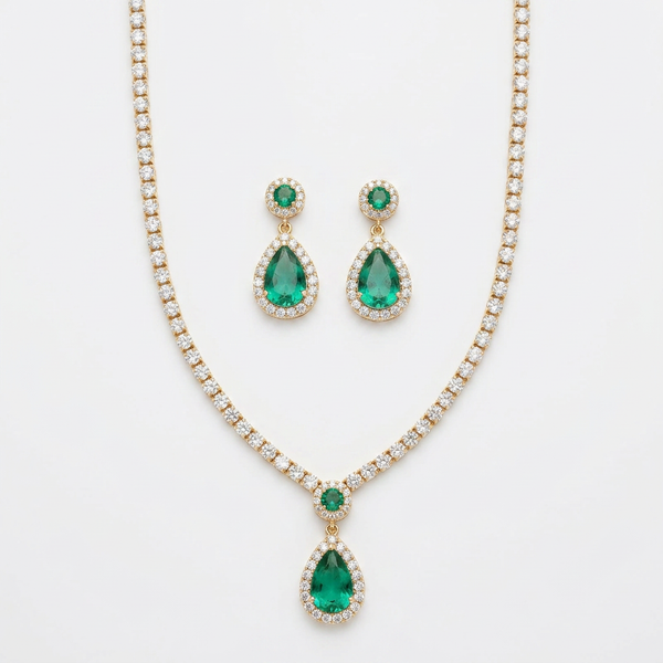 Conjunto de colar e brincos com pedra verde em formato de gota e cravejado.